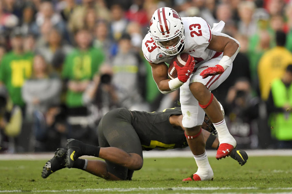 Wisconsin running back Jonathan Taylor runs past Oregon cornerback Thomas Graham Jr. during second half of the Rose Bowl NCAA college football game Wednesday, Jan. 1, 2020, in Pasadena, Calif. (AP Photo/Mark J. Terrill)