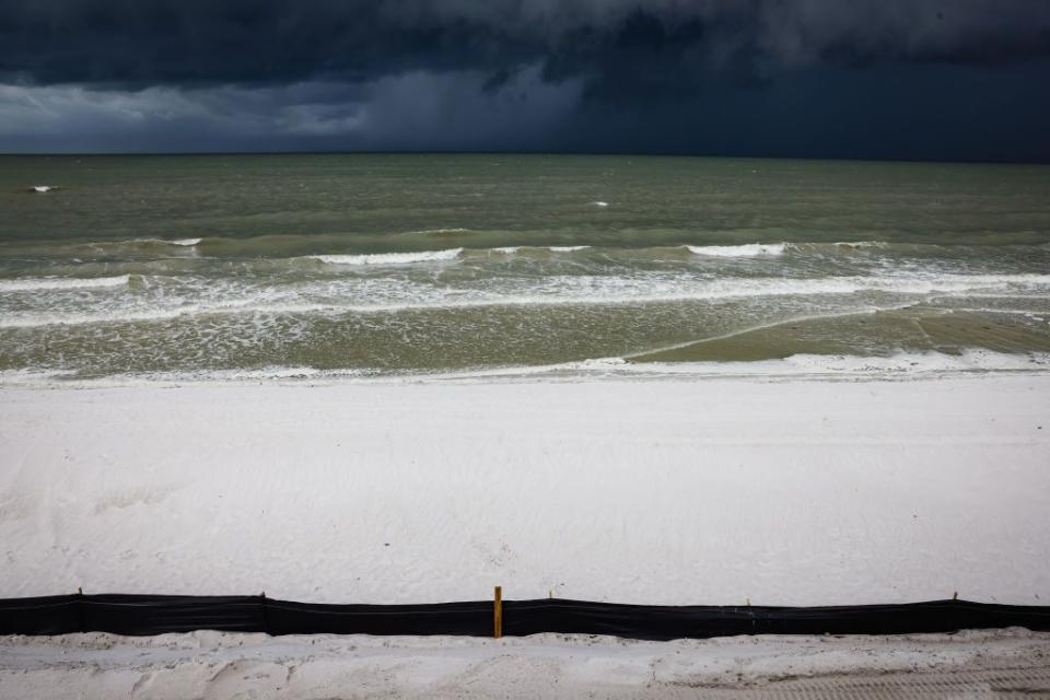 Waves crash on Fort Myers Beach during high tide on Tuesday.