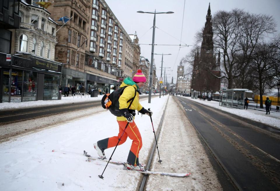 Andrea Geile skies along Princes Street in Edinburgh (PA)