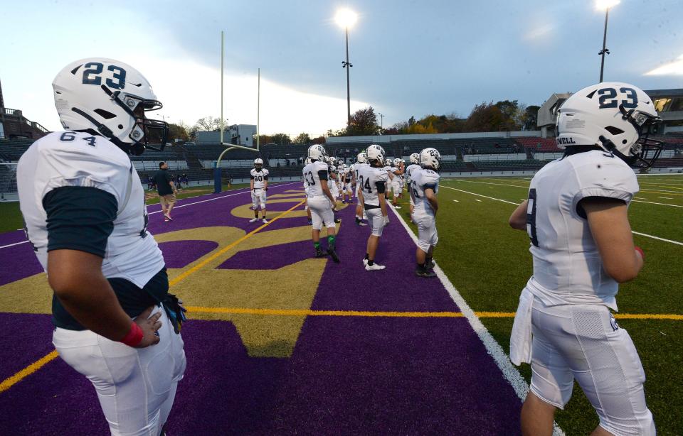 McDowell High School football players warm up before their game against Erie High on Oct. 23, 2020 at Erie Veterans Stadium. All of the McDowell players wore number 23 on their helmets in support of their teammate Jonathan Heubel, who about a month earlier collapsed on the sideline during a game against Cathedral Prepatory School and underwent rehabilitation following brain surgery.