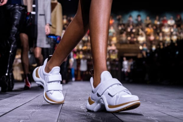 A pair of Louis Vuitton's iconic Archlight sneakers walk the house's Spring 2020 runway at Paris Fashion Week.