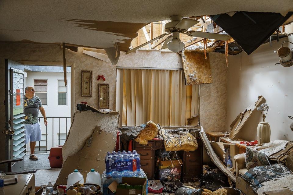 Bob Levitt returned to his condemned unit to retrieve his cat he found hiding in a bedroom at the Kings Point community in unincorporated Palm Beach County, Fla., on September 29, 2022. A tornado spawned by Hurricane Ian has left residents of the community homeless after the county deemed the structures uninhabitable.