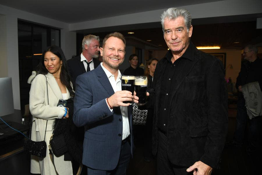 (Left to Right) Fellow Irishmen and Oscar Wilde Award honorees Richie Baneham and Pierce Brosnan share a pint at the U.S.-Ireland Alliance’s 18th annual Oscar Wilde Awards in Santa Monica. (Alberto E. Rodriguez/Getty Images for U.S.-Ireland Alliance)