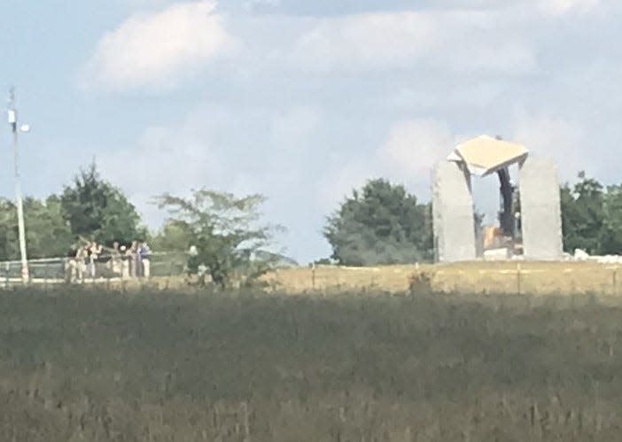 The capstone of the Georgia Guidestones north of Elberton is shown being pushed over Wednesday. The capstone, which is essential to the structure, was heavily damaged in the blast on Wednesday.