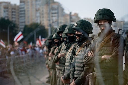 <span class="caption">Riot police blocking the road to protesters in Minsk, Belarus, in August 2020.</span> <span class="attribution"><span class="source">iVazoUSky/Shutterstock</span></span>