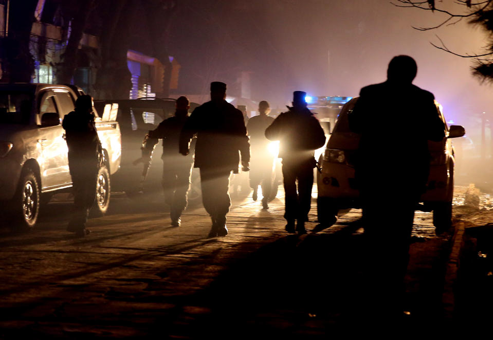 Afghan security forces arrive at the site of an explosion in Kabul, Afghanistan, Friday, Jan. 17, 2014. Afghan police said a suicide bomber attacked a Kabul restaurant popular with foreigners, officials.(AP Photo/Massoud Hossaini)