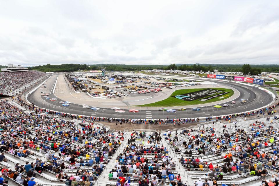 Fans watch a NASCAR Cup Series race at New Hampshire Motor Speedway.