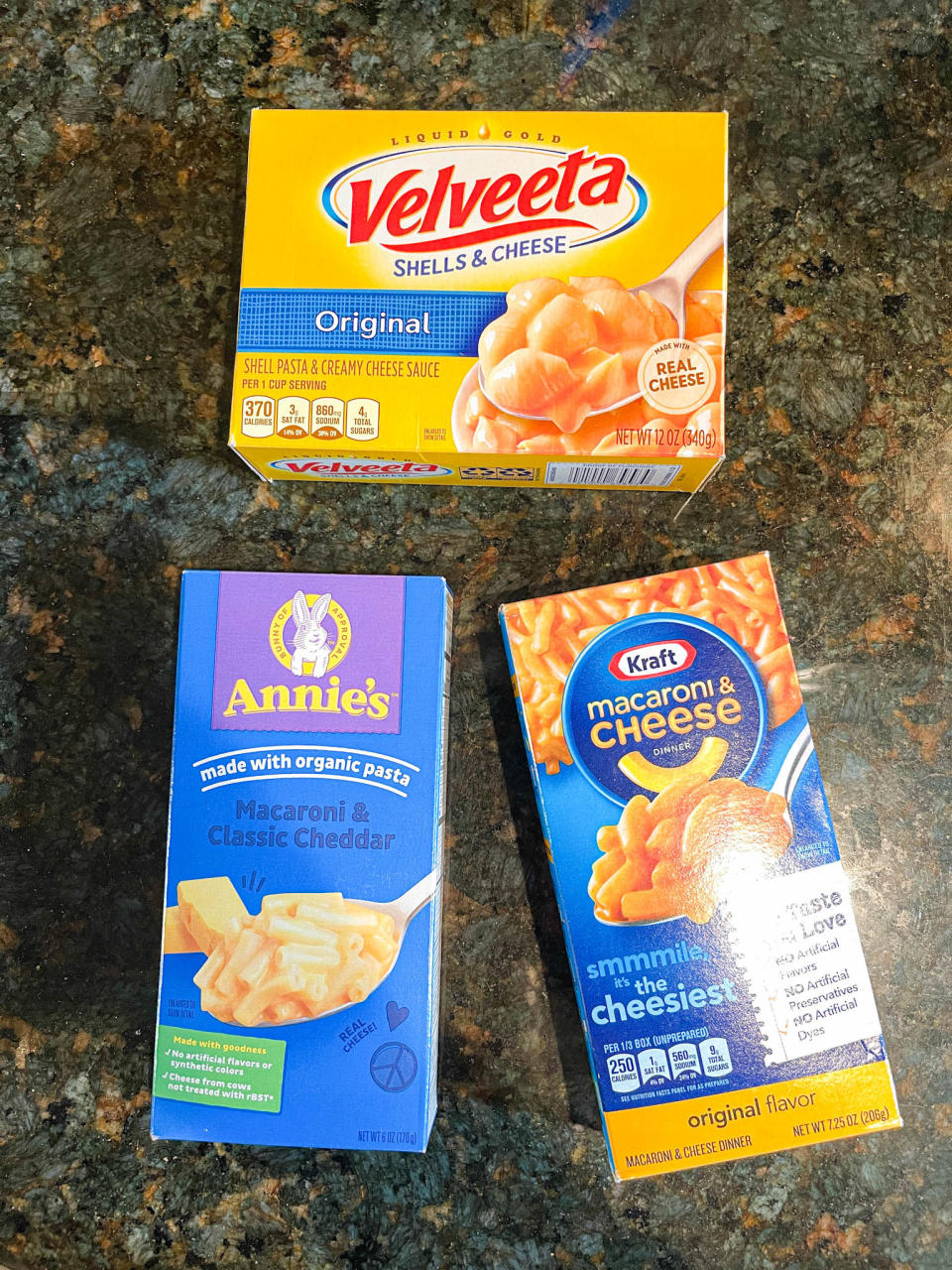 Three mac 'n' cheese boxes: Velveeta, Annie's Original, and Kraft