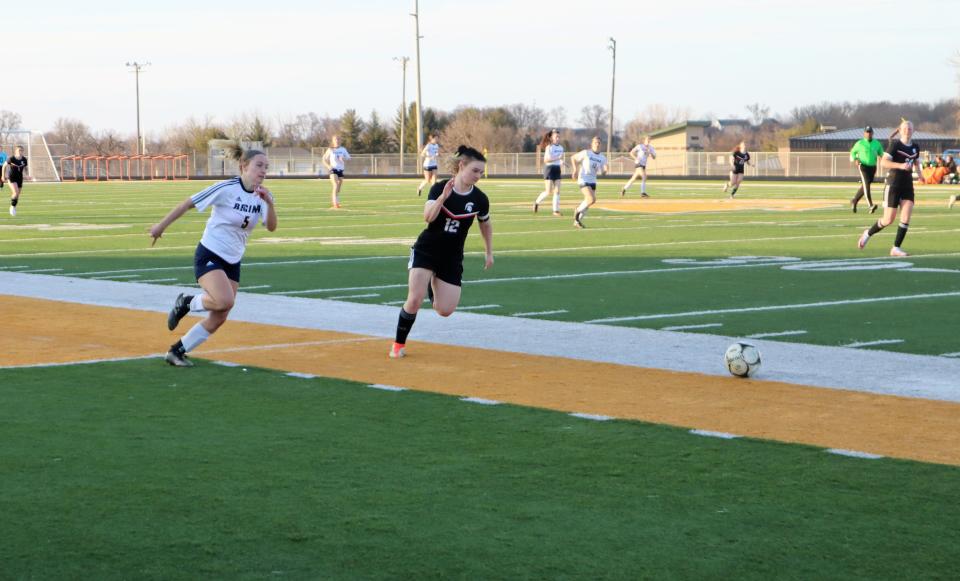 Regina's Grace Gaarde (5) racing Solon's Izzy Paisley (12) for the ball during their regular season matchup.