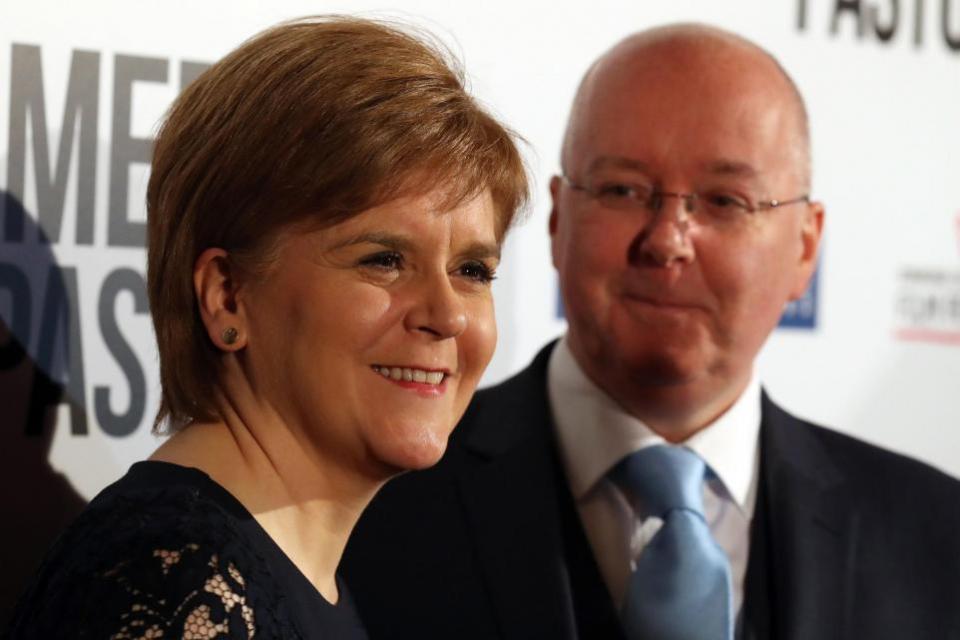 The National: Peter Murrell looks on at his wife Nicola Sturgeon