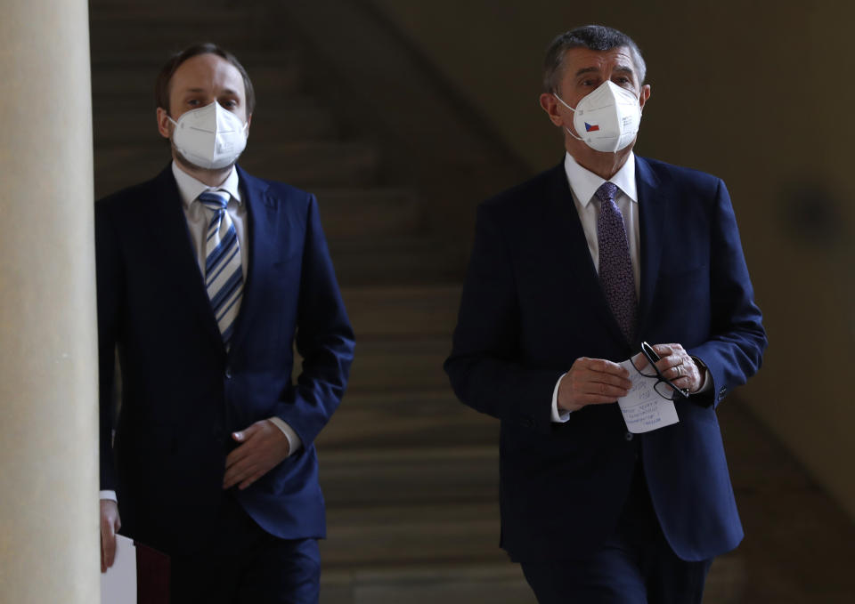 Czech Republic's Prime Minister Andrej Babis, right, and newly appointed Foreign Minister Jakub Kulhanek walk to address media at the Cernin's Palace in Prague, Czech Republic, Wednesday, April 21, 2021. Kulhanek was appointed during a Czech Russia diplomatic crisis over the alleged involvement in a fatal ammunition depot explosion in 2014. (AP Photo/Petr David Josek)