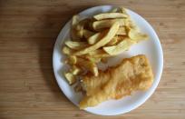 A portion of fish and chips from a fish and chip shop is pictured on a plate in Manchester