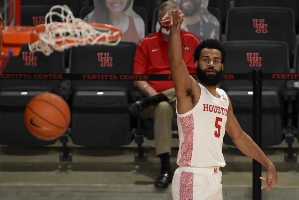 Houston guard Cameron Tyson watches his 3-point basket during the second half of an NCAA college basketball game against Lamar, Wednesday, Nov. 25, 2020, in Houston. (AP Photo/Eric Christian Smith)