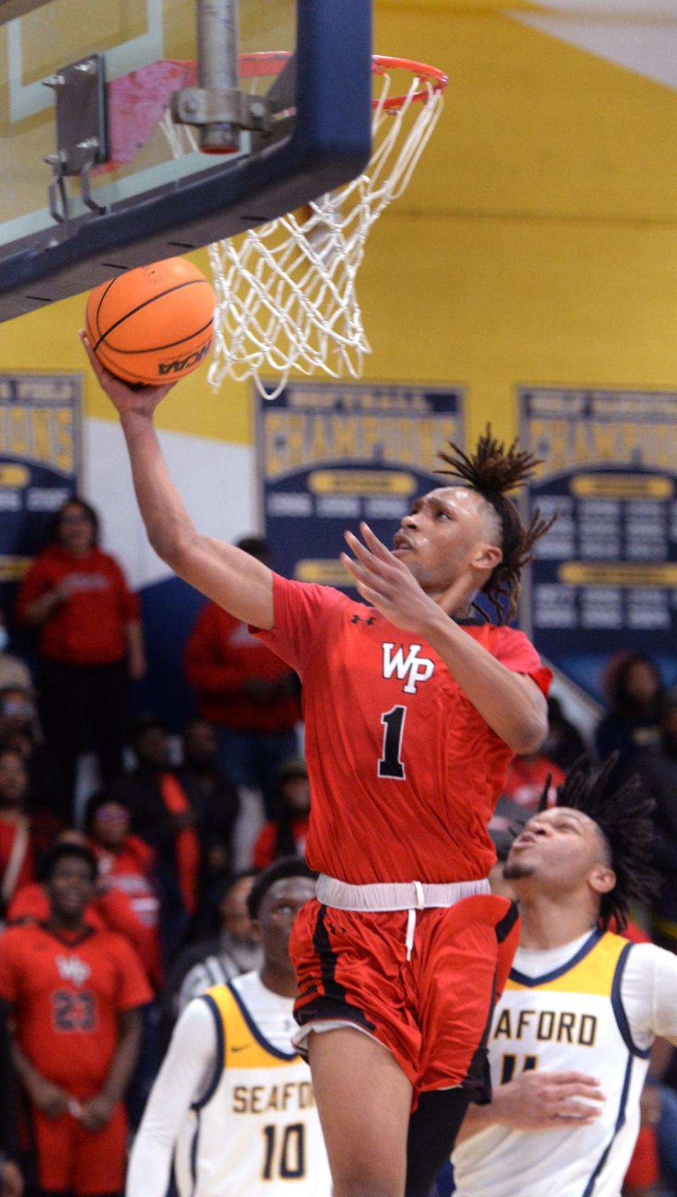 Jaiden Guy of the Colonials fights his way through the Seaford defense to score a basket late in the fourth quarter Saturday.