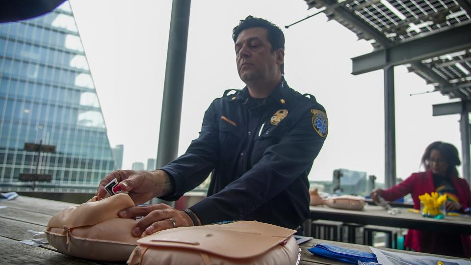 Austin-Travis County EMS Cmdr. Randy Chhabra demonstrates how to use a naloxone kit during a news conference at the Central Library in downtown Austin on Monday.