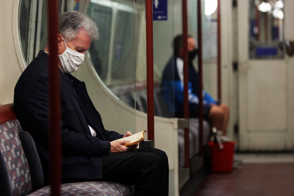 A general view of commuters wearing protective face masks on a London underground train, as the UK continues to recover from the coronavirus pandemic.