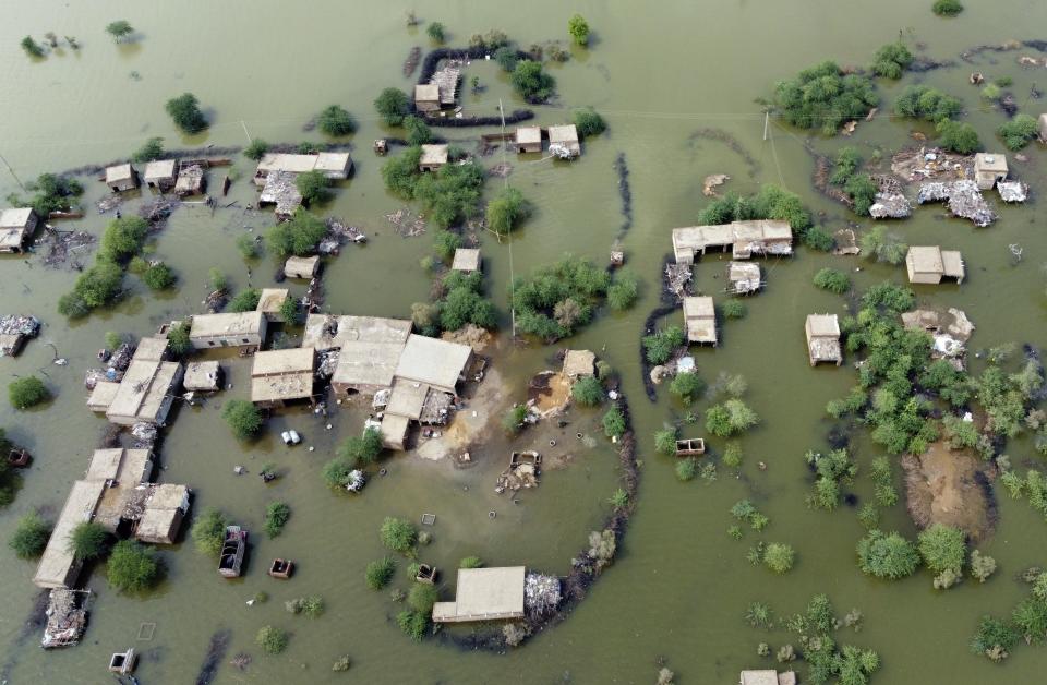 FILE - Homes are surrounded by floodwaters in Sohbat Pur city, a district of Pakistan's southwestern Baluchistan province, Aug. 30, 2022. Looking back at 2022’s weather with months of analysis, the World Meteorological Organization says last year really was as bad as it seemed. (AP Photo/Zahid Hussain, File)