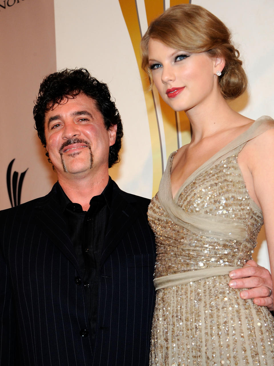 Scott Borchetta and Taylor Swift smiling for a photo