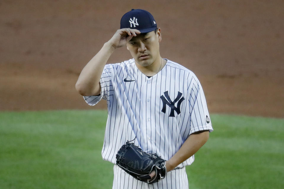 New York Yankees starting pitcher Masahiro Tanaka adjusts his padded protective cap during the third inning of the team's baseball game against the Boston Red Sox, Saturday, Aug. 1, 2020, in New York. (AP Photo/John Minchillo)