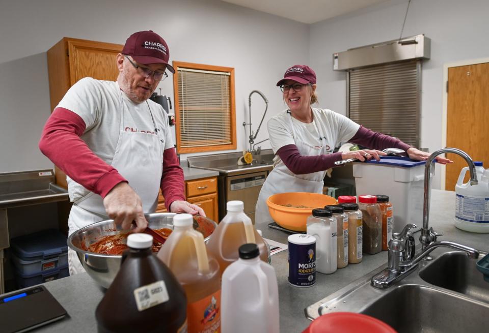 Rich and Trish Steffens of Charred Sauces and Seasonings prepare their "Charred" BBQ sauce, Wednesday, Dec. 6, 2023, in Laingsburg.