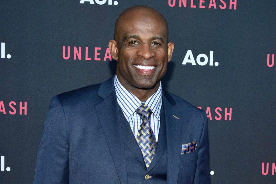 <p>Eugene Gologursky/WireImage</p> Deion Sanders poses on the red carpet at the AOL Newfront Event in New York City