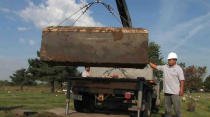 FILE - In this undated file photo provided by the Cook County Sheriff's Office, authorities exhume a box with the remains of unidentified victims of serial killer John Wayne Gacy, who was convicted of killing 33 young men and boys in the Chicago area in the 1970s. Authorities announced Monday, Oct. 25, 2021, that they have identified the remains of one more of Gacy's victims. (AP Photo/Cook County Sheriff's Office, File)