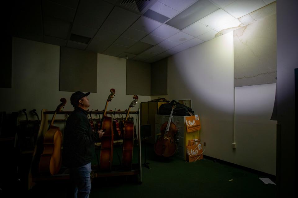 Brett Yancey, chief operations officer for Springfield Public Schools, assesses water damage to Agnes Stewart Middle School amid a power outage as winter storm recovery gets underway Thursday, Jan. 18, 2024, in Springfield, Ore.