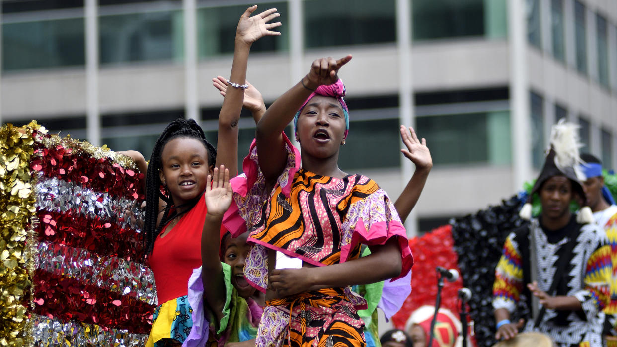 Children on a float wave to the crowd during the annual Juneteenth parade in Center City Philadelphia, PA, on June 23, 2018.