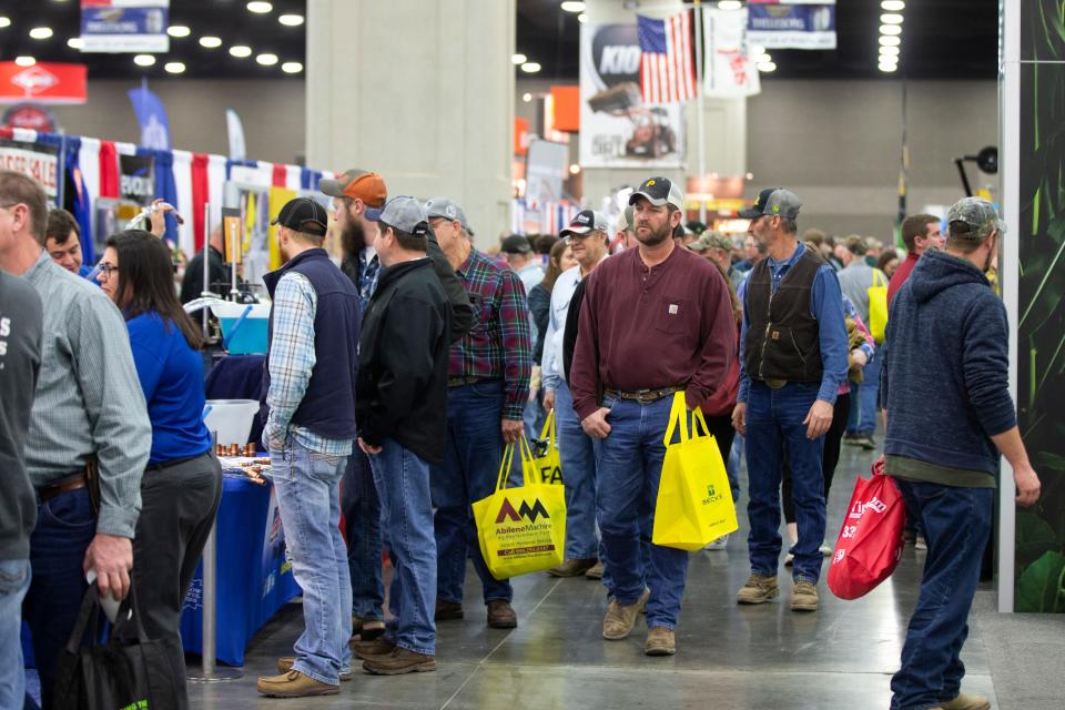 Farmers browse vendor booths and farm equipment at the National Farm Machinery Show at the Kentucky Expo Center on Feb. 12, 2020. 