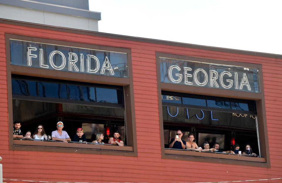 People look out the windows of FGL House in Nashville, Tenn., Saturday, June 6, 2020.