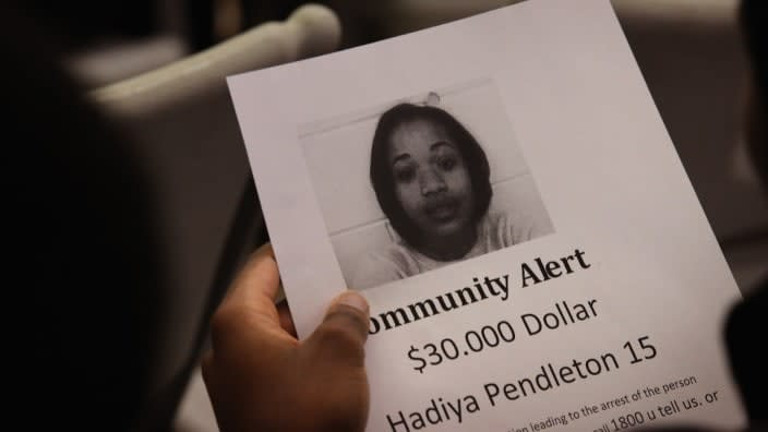 In this Feb. 2013 photo, a Chicago resident looks over a reward flyer at a community meeting inspired by the death of Hadiya Pendleton, a 15-year-old high school honor student shot and killed while hanging out with friends on a rainy afternoon. (Photo by Scott Olson/Getty Images)