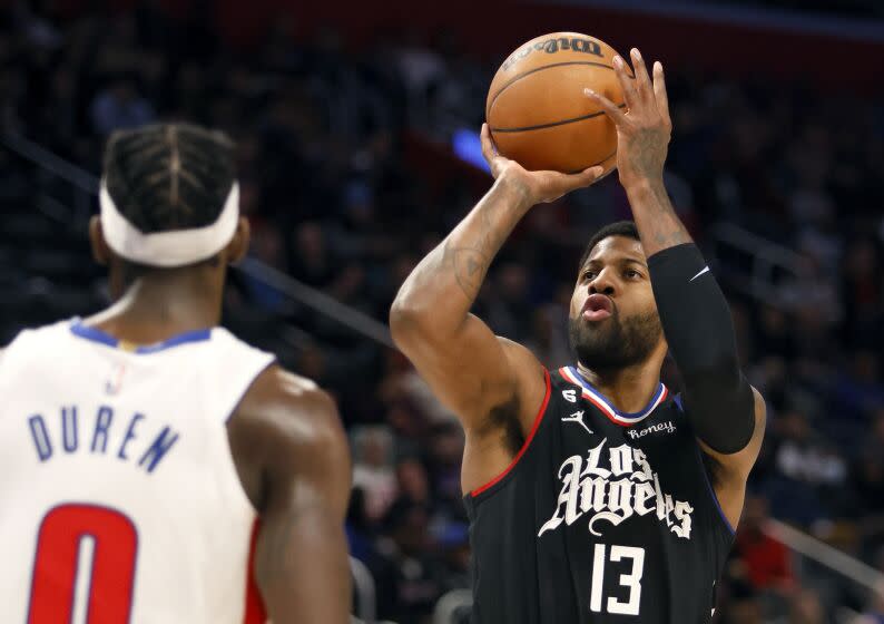 Los Angeles Clippers guard Paul George (13) looks to shoot against Detroit Pistons center Jalen Duren (0) during the first half of an NBA basketball game Monday, Dec. 26, 2022, in Detroit. (AP Photo/Duane Burleson)