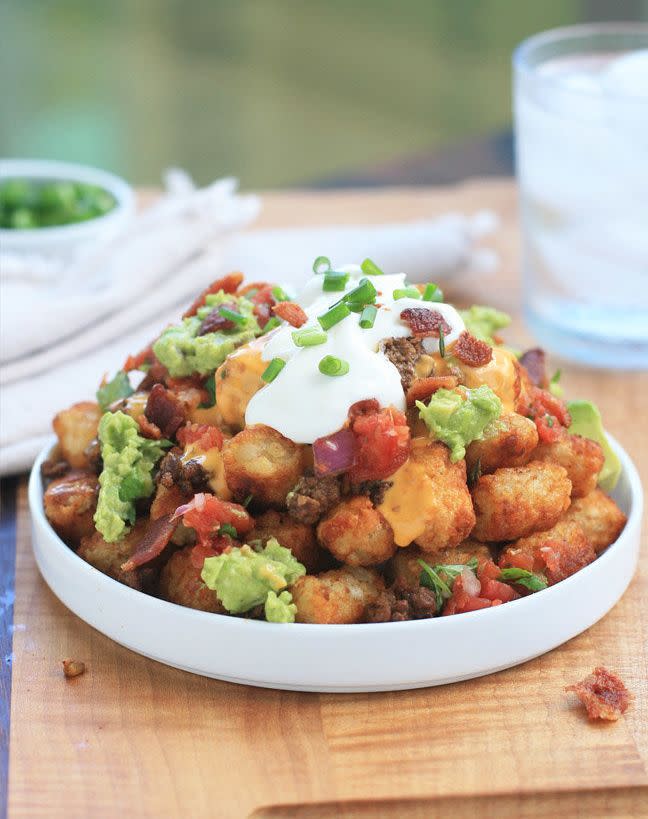<strong>Get the <a href="http://www.girlcooksworld.com/2012/10/tater-tot-nachos-supreme-aka-totchos-supreme.html">Totchos Supreme recipe from Girl Cooks World</a></strong>  Tater Tots + Nachos = Totchos (which also = love).