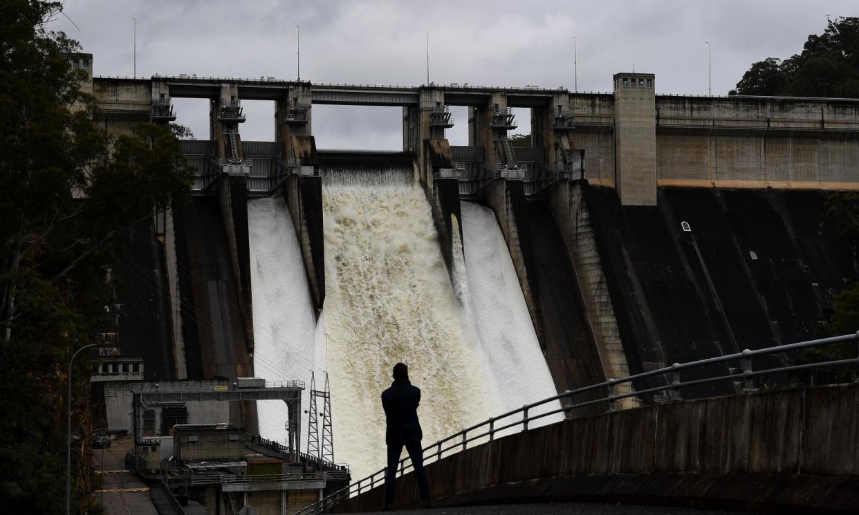 <span>A person watches NSW’s Warragamba dam spillway in south-west Sydney in 2021. The dam could spill over this Mother’s Day weekend amid severe weather warnings.</span><span>Photograph: Dan Himbrechts/AAP</span>