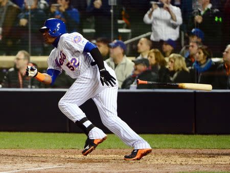 New York Mets outfielder Yoenis Cespedes (52) hits a single against the Kansas City Royals in the 9th inning in game four of the World Series at Citi Field. Jeff Curry-USA TODAY Sports