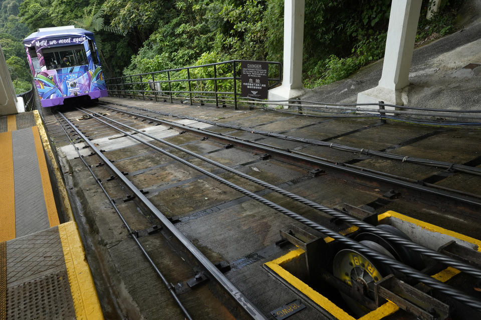 A Peak Tram passes an uphill of the Victoria Peak in Hong Kong on June 17, 2021. Hong Kong’s Peak Tram is a fixture in the memories of many residents and tourists, ferrying passengers up Victoria Peak for a bird’s eye view of the city’s many skyscrapers. (AP Photo/Vincent Yu)