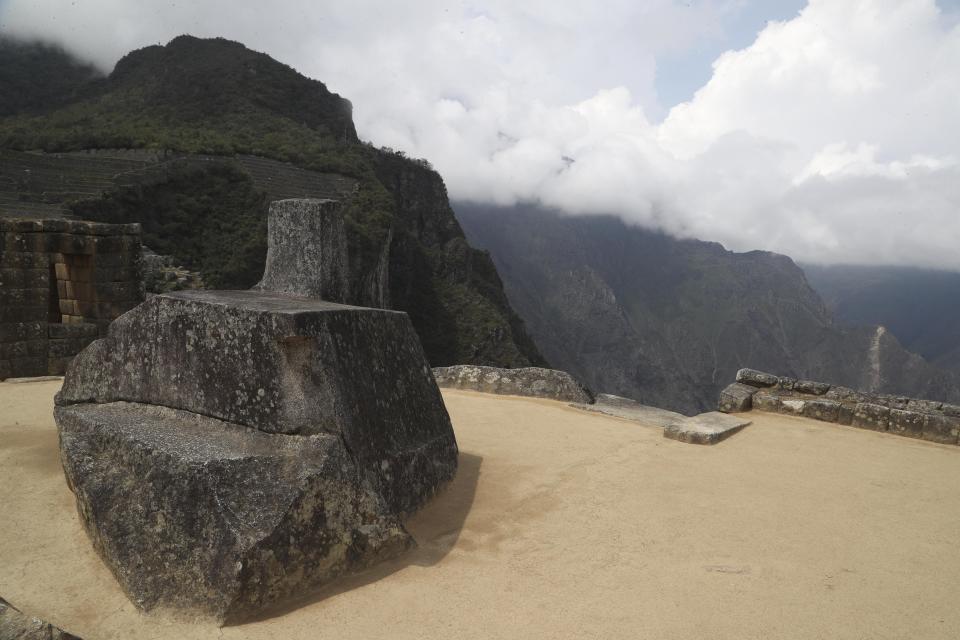 The famous sundial "Intihuatana" stands at the empty Machu Picchu archeological site, devoid of tourists while it's closed amid the COVID-19 pandemic, in the department of Cusco, Peru, Tuesday, Oct. 27, 2020. Currently open to maintenance workers only, the world-renown Incan citadel of Machu Picchu will reopen to the public on Nov. 1. (AP Photo/Martin Mejia)