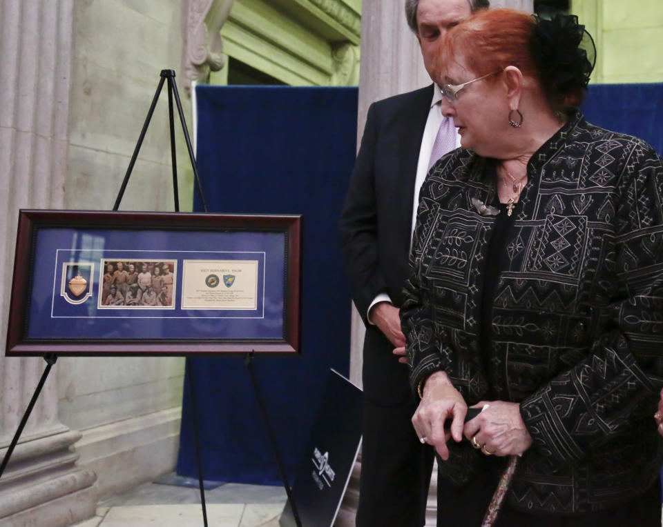 Rebecca Crofts, right, is given a previously lost Purple Heart belonging to her father, World War II Staff Sgt. Bernard Snow, during a ceremony reuniting families with previously lost Purple Hearts belonging to war veterans, on National Purple Heart Day, Monday Aug. 7, 2017, at Federal Hall in New York. (AP Photo/Bebeto Matthews)