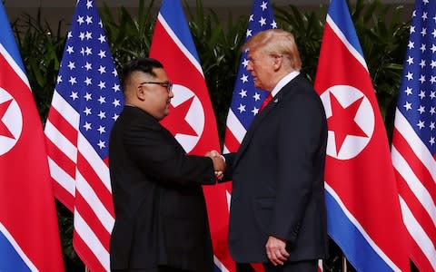U.S. President Donald Trump shakes hands with North Korean leader Kim Jong Un at the Capella Hotel on Sentosa island in Singapore - Credit: Reuters