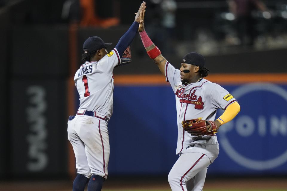 Atlanta Braves' Ronald Acuna Jr., right, celebrates with Ozzie Albies after a baseball game against the New York Mets Friday, Aug. 11, 2023, in New York. The Braves won 7-0. (AP Photo/Frank Franklin II)