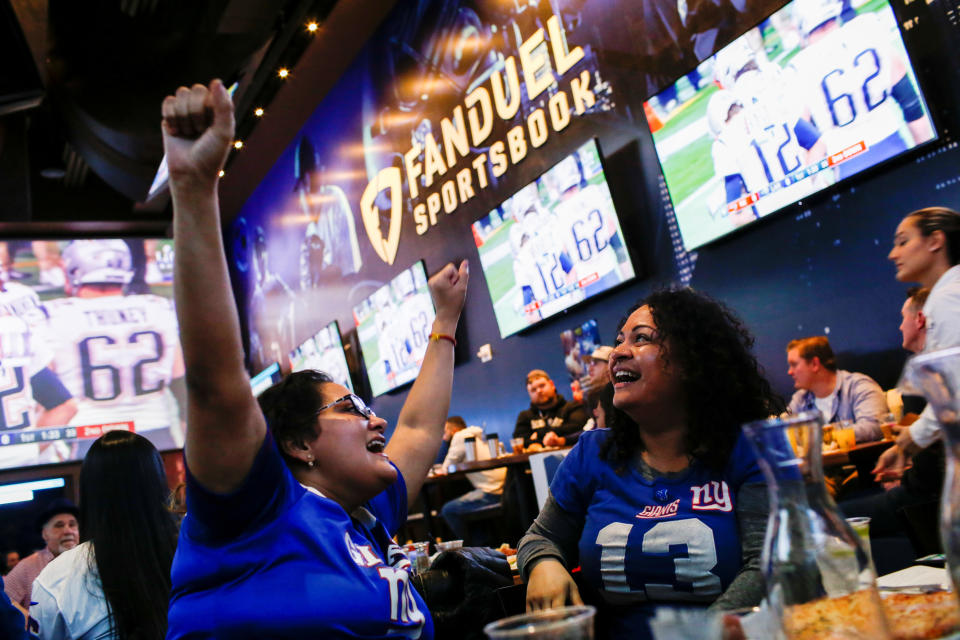 Silquia Patel, (R), 29, celebrates after making her bets at the FANDUEL sportsbook during the Super Bowl LIII in East Rutherford, New Jersey, U.S., February 3, 2019. REUTERS/Eduardo Munoz