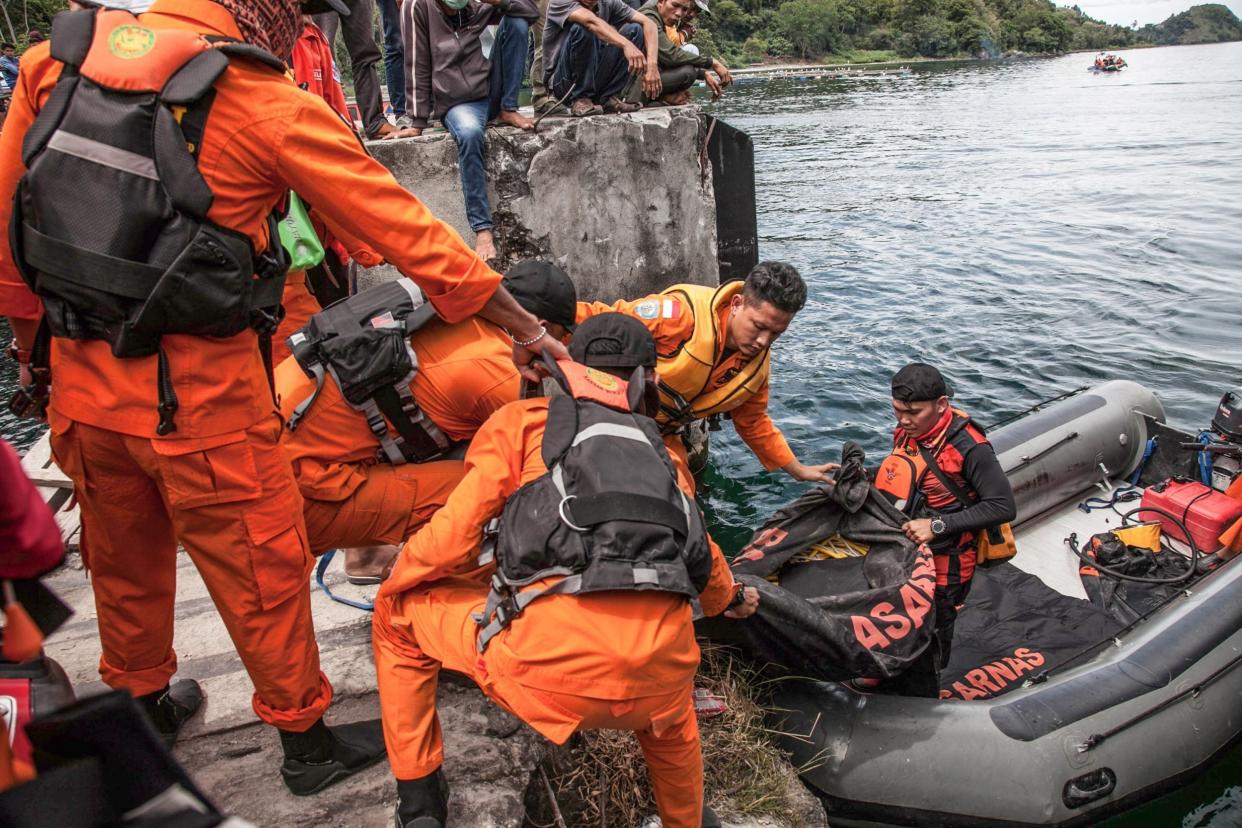 Rescue team members prepare to search for missing passengers at the Lake Toba ferry port on Wednesday: AFP/Getty