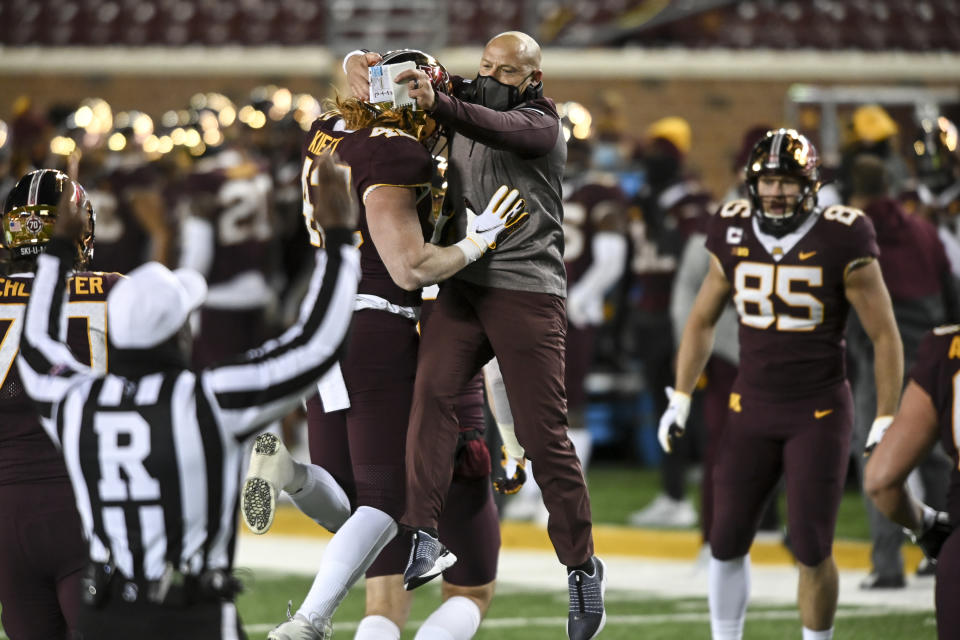 Minnesota head coach P.J. Fleck celebrates a touchdown by tight end Ko Kieft (42) in the first half of an NCAA college football game Saturday, Oct. 24, 2020, in Minneapolis, Minn. (Aaron Lavinsky/Star Tribune via AP)