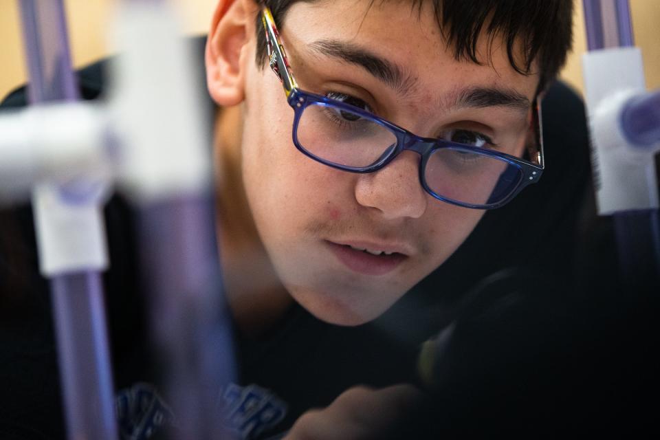 Peyton Porche, 12, inspects a propeller on an underwater robot with the Baker Middle School robotics team at the school on Friday, June 24, 2022. The team's robots will face off against others at a competition later in the year.