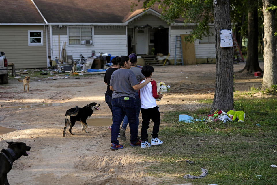 Neighbors gather for a vigil Monday, May 1, 2023, outside the home where a mass shooting occurred last week, in Cleveland, Texas. Five people were killed in the mass shooting when the suspected gunman, Francisco Oropeza, allegedly shot his neighbors after they asked him to stop firing off rounds in his yard. (AP Photo/David J. Phillip)