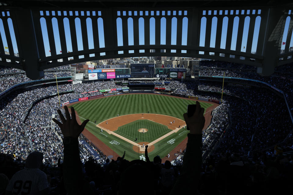 Fans react after New York Yankees' Aaron Judge hits a home run during the third inning of a baseball game against the San Francisco Giants at Yankee Stadium, Sunday, April 2, 2023, in New York. (AP Photo/Seth Wenig)