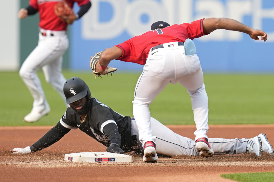Chicago White Sox's Luis Robert Jr., front left, is tagged out at second base by Cleveland Guardians shortstop Amed Rosario, right, on an attempted steal in the first inning of a baseball game Monday, May 22, 2023, in Cleveland. (AP Photo/Sue Ogrocki)