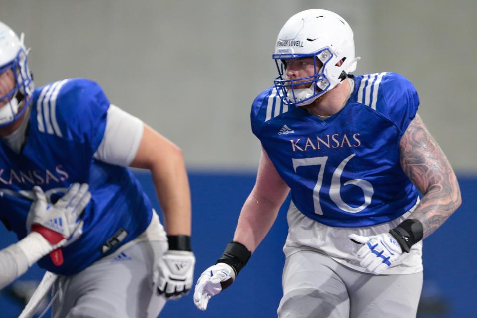 Kansas redshirt junior offensive lineman Spencer Lovell (76) works through plays during a practice at KU's Indoor Football Facility in March 2023.
