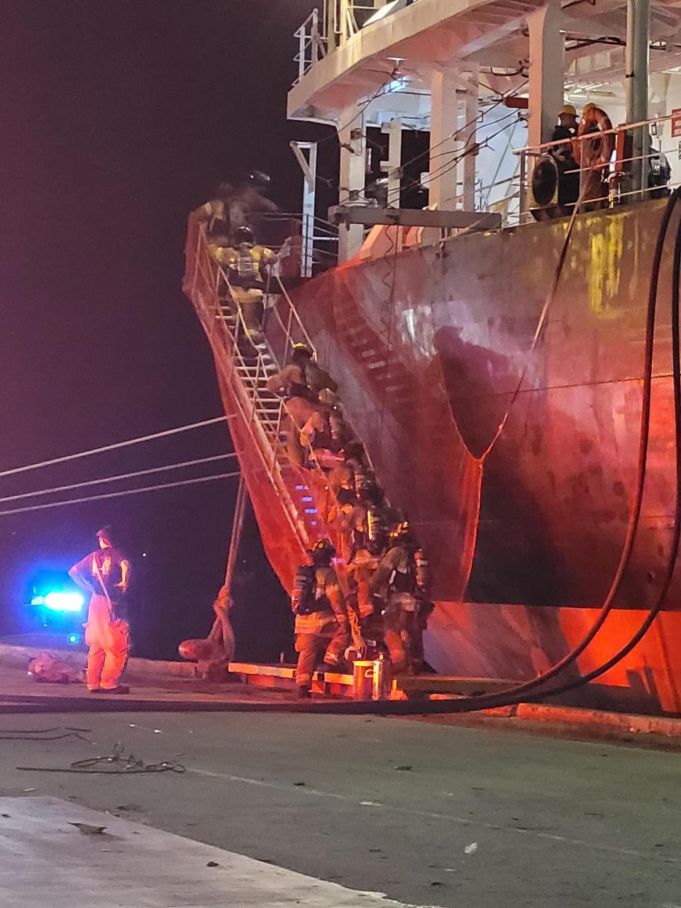 Units work to put cargo ship fire out.