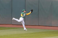 Oakland Athletics center fielder Ramon Laureano catches a fly out hit by Minnesota Twins' Mitch Garver during the fourth inning of the second baseball game of a doubleheader in Oakland, Calif., Tuesday, April 20, 2021. (AP Photo/Jeff Chiu)